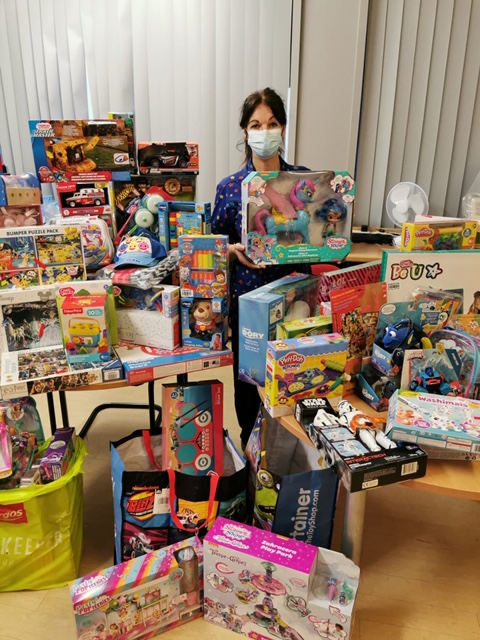 A nurse surrounded by presents