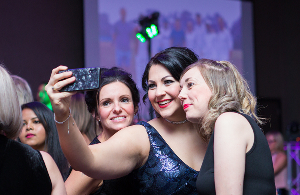 A group of ladies take a selfie at the WISHH Ball