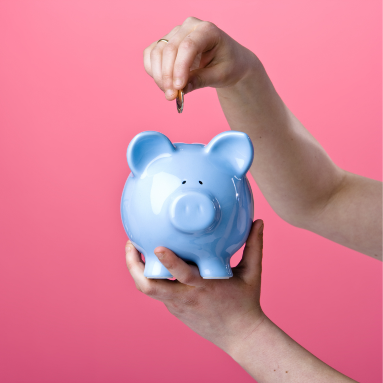 A person putting money into a piggy bank