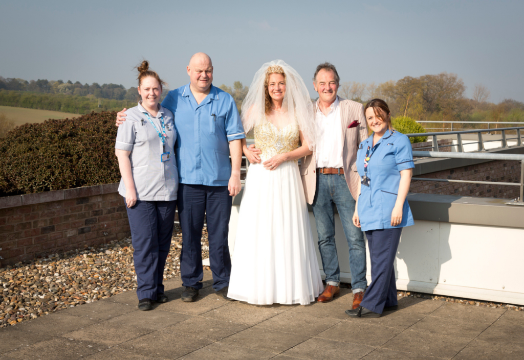 Kim and Paul Mankel on their wedding day with nurses from the Queen's centre